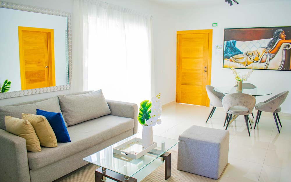 Living room with sofa, coffee table and dining area in Beach Apartamentos in Playa Palmera 